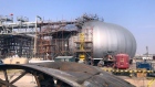 Scaffolding surrounds a primary-separation spheroid at Saudi Aramco's crude oil processing facility