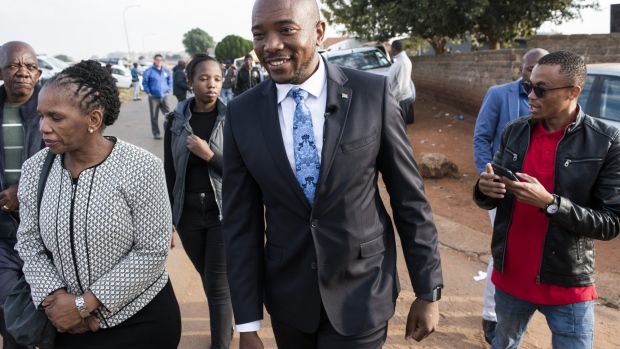 Mmusi Maimane, leader of the opposition Democratic Alliance (DA) party, center, arrives to cast his vote at a polling station during the general election in Soweto, South Africa, on Wednesday, May 8, 2019. While opinion polls point to the ruling African National Congress extending its quarter-century monopoly on power in Wednesday's vote, South African President Cyril Ramaphosa needs a decisive win to quell opposition in his faction-riven party to push through reforms needed to spur growth in Africa's most-industrialized economy. Photographer: Waldo Swiegers/Bloomberg