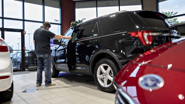 A customer looks over a Ford 2020 Explorer on display at a car dealership in Orland Park, Illinois. Photographer: Daniel Acker/Bloomberg
