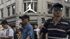 Pedestrians walk past a Nike Inc. Air Jordan store in Shanghai, China, July 29, 2019.