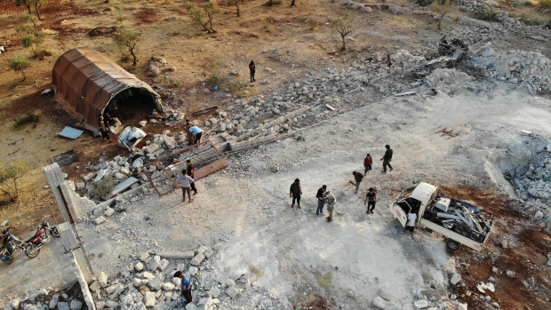 People inspect a site that was hit by helicopter gunfire near Barisha, Syria on Oct. 27. 