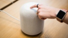 An employee demonstrates the HomePod speaker on the first day of sales at an Apple Inc. store in New
