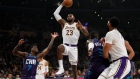 Los Angeles Lakers forward LeBron James, center, goes up for a shot past Charlotte Hornets guard Dwa