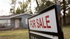 A "For Sale" sign stands outside a home in Peoria, Illinois, U.S., on Tuesday, Oct. 20, 2015. Sales of previously owned U.S. homes rebounded in September to the second-highest level since February 2007, the latest sign that the recovery in residential real estate will support growth in the worlds largest economy. 