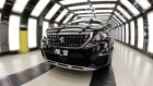 A Peugeot 3008 compact SUV drives through a light tunnel at the Peugeot plant in Sochaux, France. 
