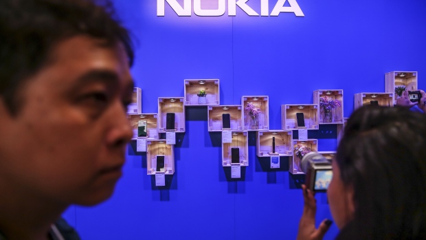 An attendee takes a photograph of a Nokia handset display during a HMD Global Oy launch event ahead of the MWC Barcelona in Barcelona, Spain, on Sunday, Feb. 24, 2019. At the wireless industry’s biggest conference, over 100,000 people are set to see the latest innovations in smartphones, artificial intelligence devices and autonomous drones exhibited by more than 2,400 companies. 