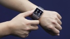 An attendant shows a Fitbit Inc. Ionic smartwatch for a photograph at the Wearable Expo in Tokyo. 