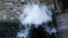 A pedestrian stands surrounded in a cloud of vapour after exhaling from a vape device in London, U.K., on Thursday, Oct. 17, 2019. Vaping has helped tens of thousands of Britons quit smoking each year, a study showed, underlining the U.K.'s more tolerant stance on the alternative to cigarettes as a backlash grows in the U.S.