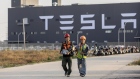 Workers walk outside the Tesla Inc. Gigafactory in Shanghai, China, Nov. 1, 2019. Bloomberg/Qilai Sh