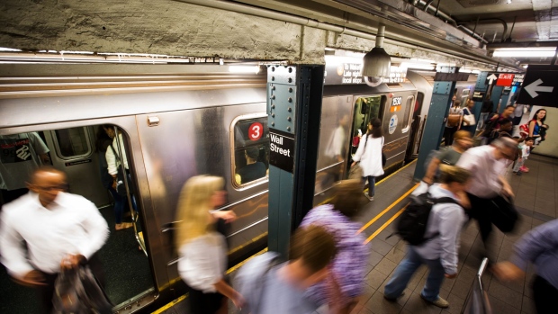 Commuters exit a train at the Wall Street subway station near the New York Stock Exchange (NYSE) in New York, U.S., on Monday, Sept. 17, 2018. U.S. stocks started the week lower, while Asian equities slumped and European shares were little changed, as investors grappled with the latest American threats to expand tariffs on Chinese goods. 