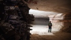 A miner stands near the cutting head of a digger near an active mining wall at the Nutrien Ltd. Cory
