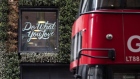 A bus passes the WeWork slogan 'Do What You Love' displayed on a window of the co-working office space, operated by the parent company We Co., on City Road in London, U.K., on Monday, Oct. 7, 2019. While WeWork has been rapidly expanding in Canada, the New York-based company is facing challenges on multiple fronts with Landlords in London and New York the most exposed to any further deterioration at the co-working firm. 