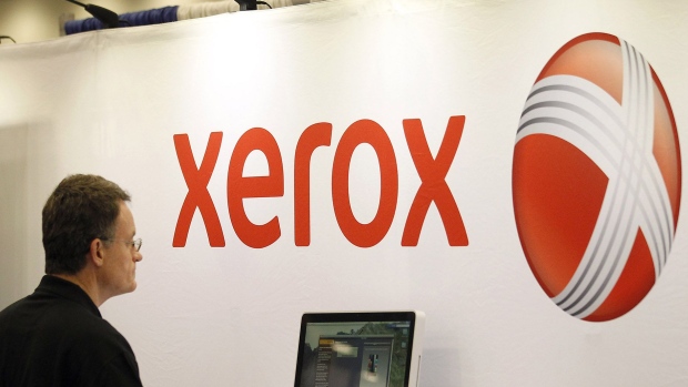 The Xerox logo is displayed at their booth at a conference. 