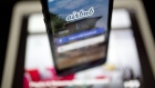 The Airbnb Inc. application is displayed on an Apple Inc. iPhone and iPad in this arranged photograp