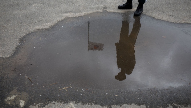 A South Korean soldier standing next to a South Korean flag is reflected in a puddle at the Daeseong-dong village in the Demilitarized Zone (DMZ) in Paju, South Korea, on Tuesday, April 24, 2018. The leaders of the two Koreas are set to hold their first summit since 2007 on April 27, and officials are taking a series of diplomatic steps to lay the ground for the historic meeting. 