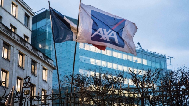 A French national flag and a flag displaying the AXA SA logo fly outside the insurance company's headquarters in Paris, France, on Tuesday, March 6, 2018. 