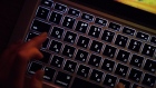 A person uses a laptop computer with illuminated English and Russian Cyrillic character keys in this arranged photograph in Moscow, Russia, on Thursday, March 14, 2019