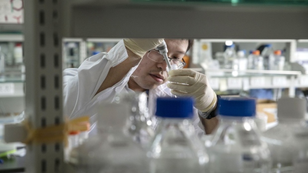 A researcher operates equipment inside a laboratory at BeiGene Ltd.'s research and development center in Beijing, China, on Thursday, May 24, 2018. Biotech company BeiGene is worth about $9 billion on the Nasdaq, a multiple of about seven times its 2016 IPO, and its experimental cancer drugs are being closely watched globally. Photographer: Gilles Sabrie/Bloomberg