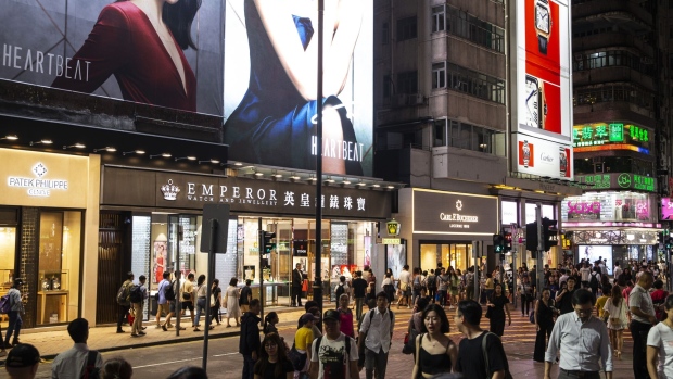 Pedestrians walk along Russell Street in the Causeway Bay district of Hong Kong, China, on Thursday, Aug. 29, 2019. Whether it's glitzy shops in Central or decades-old family businesses along the city's winding streets, retailers of all levels across Hong Kong these days find themselves struggling in much the same way. 