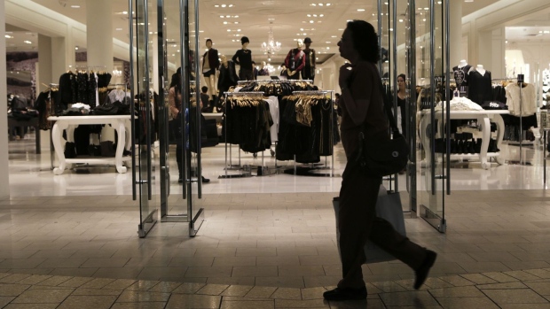 A woman carries a shopping bag at a mall in Fairfax, Virginia. 