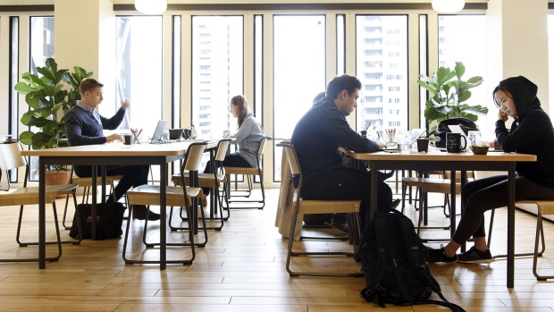 Members work on laptop computers in a common room at the Embarcadero WeWork Cos Inc. offices in San Francisco, California, U.S. 