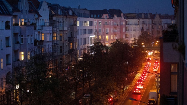 Automobile tail lights illuminate a road of residential apartment blocks in the Prenzlauer Berg district of Berlin, Germany, on Wednesday, Oct. 23, 2019. Berlin’s governing parties struck a deal to freeze rents for five years, marking one of the most radical plans to tackle spiraling housing costs in a major city and hitting the shares of major apartment owners. 