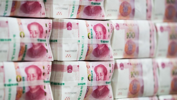 Genuine bundles of Chinese one-hundred yuan banknotes are arranged for a photograph at the Counterfeit Notes Response Center of KEB Hana Bank in Seoul, South Korea, on Monday, Aug. 14, 2017. China's factory output and investment slowed somewhat in July, according to data released today, yet the yuan appeared not to take the data as negative, if in fact it's paying attention to it at all. 