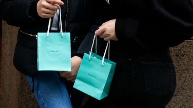 Shoppers hold bags from the Tiffany & Co. store on Fifth Avenue in New York, U.S., on Monday, Oct. 28, 2019.