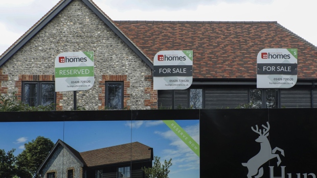 Estate agents for sale advertising boards stand on the Hunters Wood new housing development by Project 26 Ltd. at Liphook, U.K., on Wednesday, Nov. 20, 2019. The U.K. still suffers from an imbalance between the demand for housing and the volume of new houses being built, so any party campaigning for government would likely have to address this as part of their policy platform. 