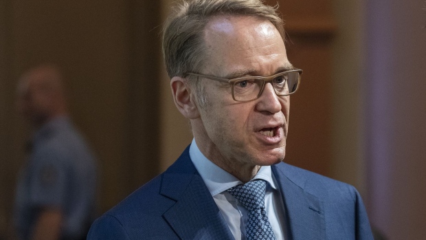 Jens Weidmann, president of the Deutsche Bundesbank, speaks with an attendee at the Deutsche Bundesbank financial market conference in Frankfurt, Germany, on Tuesday, Oct. 29, 2019. Weidmann warned that giving preference to green bonds when conducting quantitative easing policies risks overburdening central banks and could eventually endanger their independence. 