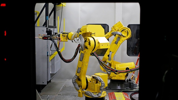 Robots operate inside a manufacturing booth at the General Electric Co. (GE) energy plant in Greenville, South Carolina, U.S., on Tuesday, Jan. 10, 2017. General Electric Co. is scheduled to release earnings figures on January 20. 