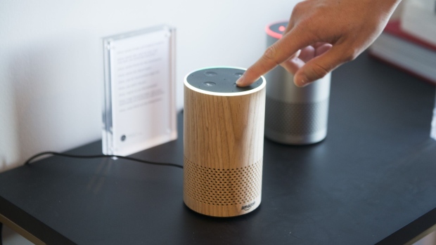An attendee operates the new Amazon.com Inc. Echo device on display during the company's product reveal launch event in downtown Seattle, Washington, U.S., on Wednesday, Sept. 27, 2017