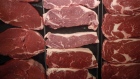 Beef steaks are displayed for sale