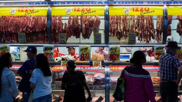 Customers wait to buy meat from at a butchery stall inside a market in Sao Paulo, Brazil, on Saturday, March 18, 2017. Federal authorities announced Friday they're investigating evidence that companies including JBS SA and BRF SA, the nation's largest meat producers, bribed government officials to approve the sale and export of soiled meat. 