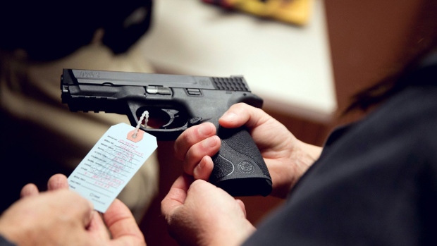 BRIDGETON, MO - NOVEMBER 12: Customers shop for a handgun at Metro Shooting Supplies on November 12, 2014 in Bridgeton, Missouri.