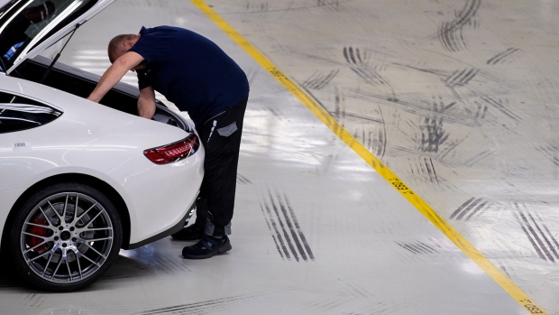 An employee carries out final quality control checks on a newly assembled Mercedes-Benz AG AMG GT high performance luxury automobile at the automaker's plant in Sindelfingen, Germany, on Monday, Dec. 18, 2017. The 2018 Mercedes-Benz GT R sports car sits at the top of the Mercedes AMG GT line, with a 4.0-liter V8 bi-turbo engine that gets 577 horsepower and can hit 60 mph in 3.5 seconds. 