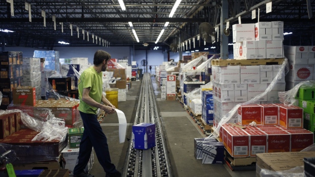 A worker stands next to a conveyor belt in a warehouse at Southern Glazer's Wine and Spirits LLC distribution center in Louisville, Kentucky, U.S., on Wednesday, Sept. 18, 2019. Constellation Brands is scheduled to release earnings figures on October 3. 