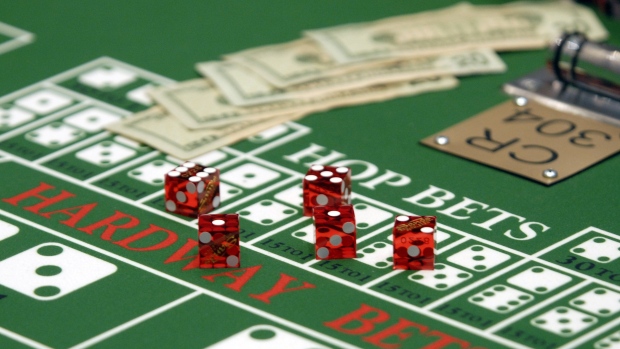Cash and dice sit on a craps table 