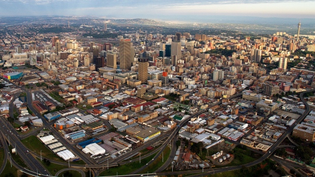 The central business district, also known as Johannesburg CBD, center, and the M2 highway, left, is seen in this aerial view of the city skyline in Johannesburg, South Africa, on Saturday, Dec. 14, 2013. While Johannesburg flourished after the discovery of gold in 1886 the stress that the mining has placed on underground rock formations has increased seismic activity. 