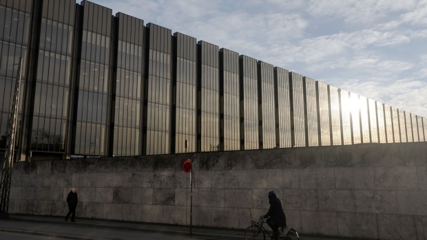 A cyclist passes Denmark's central bank, also know as Danmarks Nationalbank, in Copenhagen, Denmark, on Thursday, Jan. 3, 2019. For the first time in almost three years, the central bank of Denmark has bought kroner to support its euro peg through a direct intervention in the currency market. 