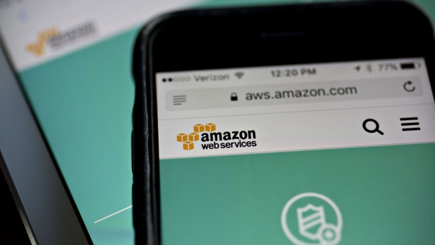 The Amazon.com Inc. Amazon Web Services (AWS) Shield website is displayed on an Apple Inc. iPhone and iPad in Washington, D.C., U.S., on Monday, Dec. 5, 2016. Amazon.com unveiled a new security tool for cloud customers last week, part of a slew of product announcements designed to fend off competition from Microsoft Corp., Alphabet Inc.'s Google and others in the fast-growing cloud computing market. 