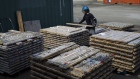 A worker stacks core samples outside a core shack at the Agnico Eagle Mines