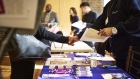 A job seeker, left, shakes hands with a representative during a Shades of Commerce Career Fair in the Brooklyn borough of New York, U.S., on Saturday, Feb. 17, 2018. The latest initial jobless claims, which correspond to the February employment survey period, fell from the previous week to a five-week low and continue to flirt with multi-decade lows. 