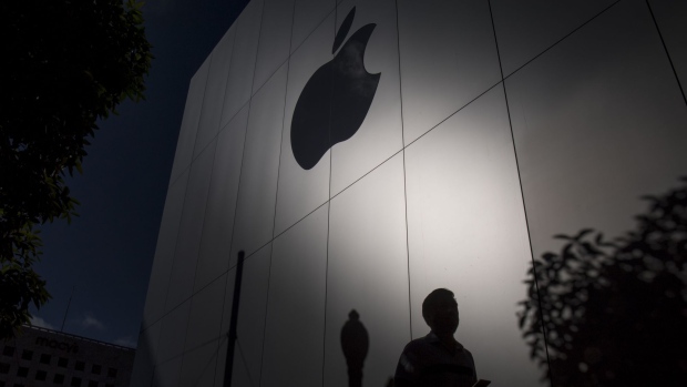 The silhouette of a pedestrian is seen in front of the Apple Inc. store during the sales launch of the Apple Inc. iPhone 8 smartphone, Apple watch series 3 device, and Apple TV 4K in San Francisco, California, U.S. 