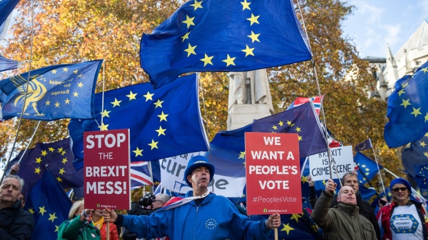Anti-Brexit campaigners protest outside the Houses of Parliament in the Westminster district of London, U.K., on Monday, Nov. 19, 2018. Ever since Prime Minister Theresa May announced her Brexit deal, she has sought to go over the heads of her critics and appeal directly to voters to back her plan. 