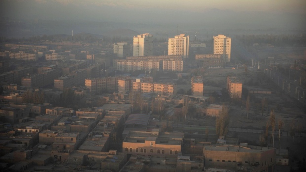 Buildings stand shrouded in haze at sunrise in Kashgar, Xinjiang autonomous region, China, on Friday, Nov. 9, 2018. Although it represents just 1.5 percent of China's population and 1.3 percent of its economy, Xinjiang sits at the geographic heart of Xi's signature Belt and Road Initiative. Source: Bloomberg/Bloomberg