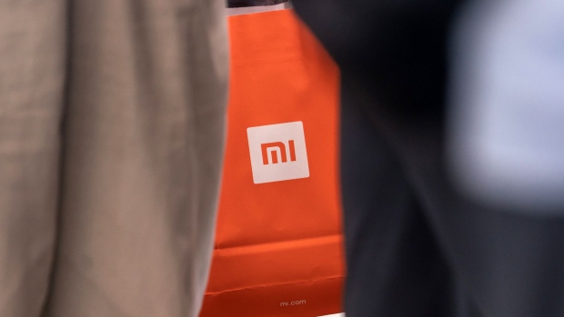 A Xiaomi Corp. branded shopping bag is seen inside a Xiaomi store in Hong Kong, China, on Friday, July 6, 2018. The tussle over Xiaomi's high valuation and concern over a U.S.-China trade war have overshadowed what had been one of the world's most highly-anticipated initial public offerings of the year. 