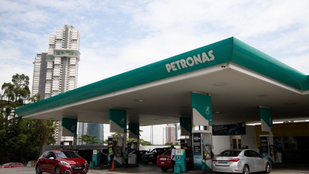 Vehicles are refueled at a Petroliam Nasional Bhd. (Petronas) gas station in Johor Bahru, Johor, Malaysia, on Thursday, June 20, 2019. Malaysia's Prime Minister Mahathir Mohamad said he underestimated the challenges of governing the country before his shock election victory last year. “I underestimated because we were on the outside and we didn’t get any information on what was happening on the inside,” Mahathir said. 