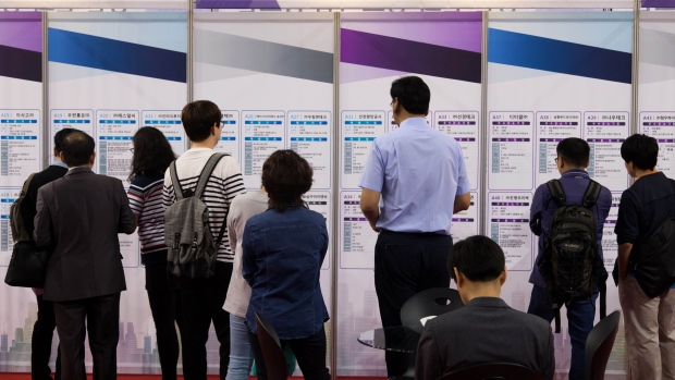 Jobseekers look at listings displayed at a job fair in Incheon, South Korea, on Wednesday, May 24, 2017. South Korea is scheduled to release first-quarter gross domestic product (GDP) figures on June 2. 