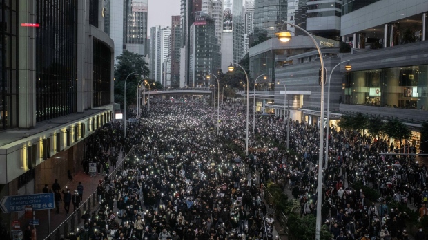 Demonstrators shine lights from their smartphones as they march along Queensway during a protest in the Admiralty district of Hong Kong, China, on Sunday, Dec. 8, 2019. Hundreds of thousands of people marched through Hong Kong to mark Human Rights Day and press for greater democracy in the city. 